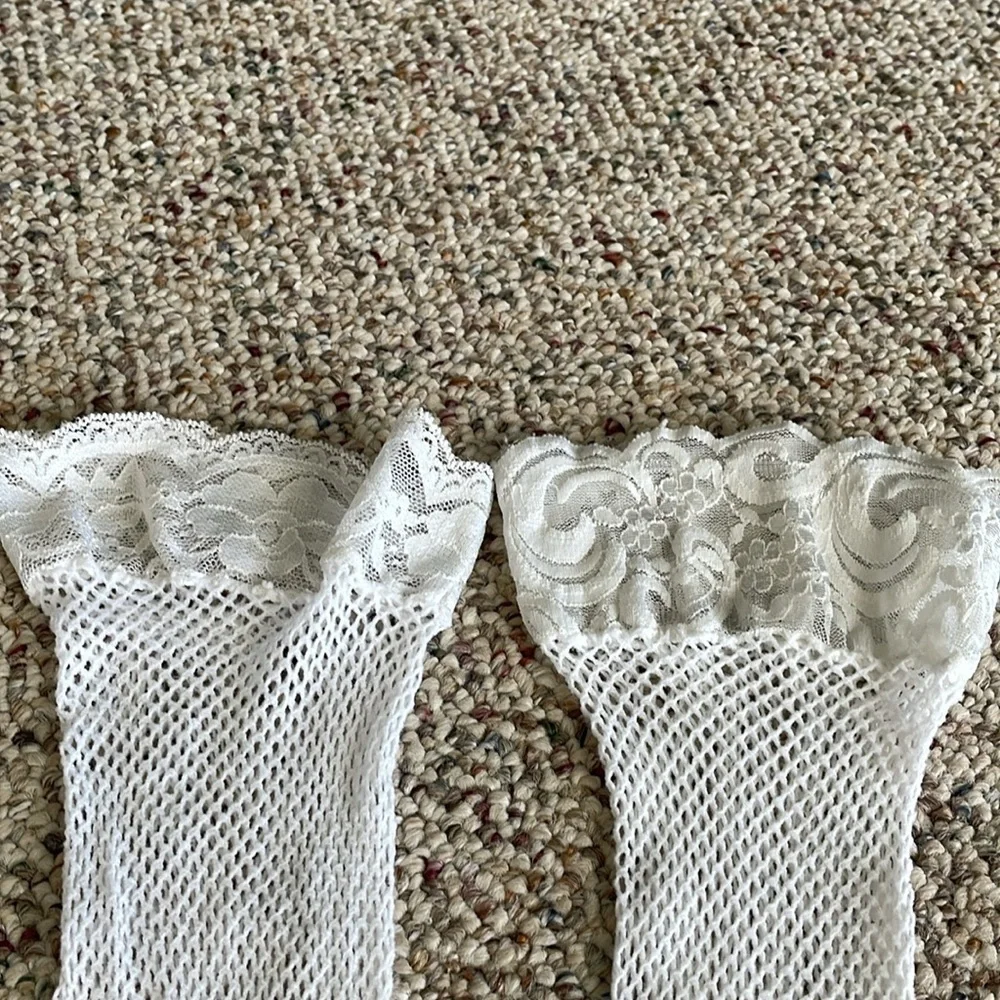 Pair Of Mismatched Fishnet Thigh High’s